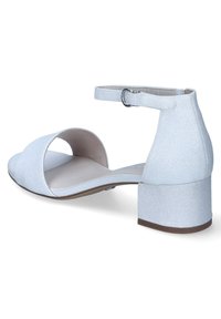 White glitter open-toe sandal with ankle strap, medium block heel, smooth inner lining, and curved upper design.
