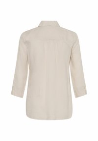 Jasnobeżowa, długosleeve koszula wykonana z teksturowanego lnu. Posiada kołnierzyk, detal w formie pliski z tyłu oraz boczne rozcięcia u dołu.
