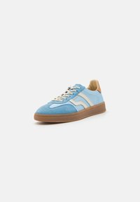 Light blue suede sneaker with cream accents, beige laces, tan heel tab, and brown rubber sole against white background.