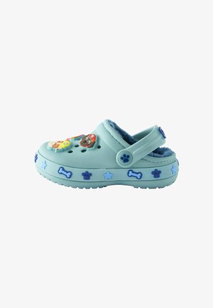 Light blue clog with fuzzy interior, featuring colorful animal-themed decorations and bone and paw prints along the sole. Adjustable back strap.