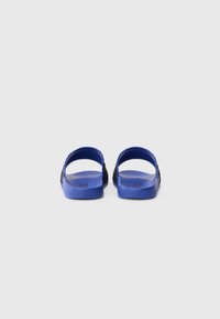 Blue heeled sandals with a textured footbed and black accents. Open back design with wide straps and a smooth finish.