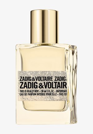Eau de parfum Zadig & Voltaire This Is Really Her! dans un flacon rectangulaire en verre transparent avec un bouchon doré. 30 ml.