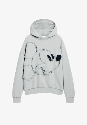 Sudadera gris claro con un gran diseño de Mickey Mouse contorneado en negro, que cuenta con capucha, corte holgado y detalles de borde desflecado en los dobladillos.