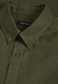 Khaki košeľa na gombíky s mäkkou textúrou, so štruktúrovaným golierom, dvoma prednými gombíkmi a jemným detailom šitia. Viditeľná značka.