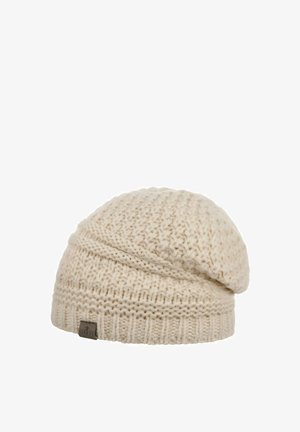 Cream-colored knitted wool beanie with textured stitch pattern and a small brown rectangular tag on the ribbed cuff.