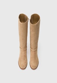 Pair of tan suede knee-high boots with a side zipper and decorative strap detail, viewed from above on a white background.