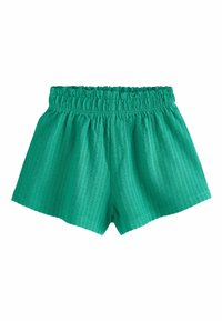 Shorts en coton vert avec un tissu texturé, une taille élastique et une coupe ample. L'ourlet est droit, offrant un style décontracté.