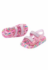 Sandales roses avec des motifs de licorne et d'arc-en-ciel, dotées de brides pailletées et de fermetures ajustables pour un maintien sécurisé. Fabriquées en matériau doux.
