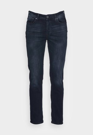 Dark blue denim jeans with a slim fit, featuring a button closure, five pockets, and subtle fading. Smooth texture, straight leg design.