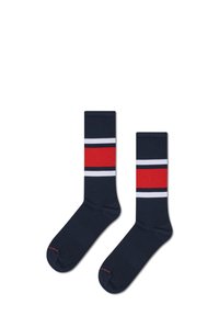 Skarpetki w kolorze granatowym z dwoma poziomymi paskami w kolorze czerwonym i białym na środkowej części; tekstura żebrowana; w jednolitym kolorze przez cały czas.