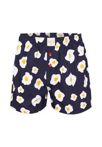 Boxer in blu navy con stampa di uova fritte in bianco e giallo su tutta la superficie, dotati di due bottoni rossi sul davanti e un elastico in vita.