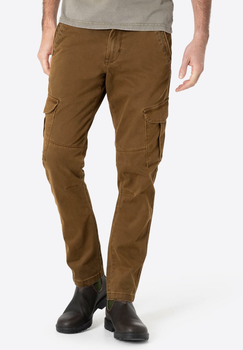 Brown cargo pants made of soft cotton, featuring side pockets, a straight leg design, and reinforced seams, paired with dark ankle boots.