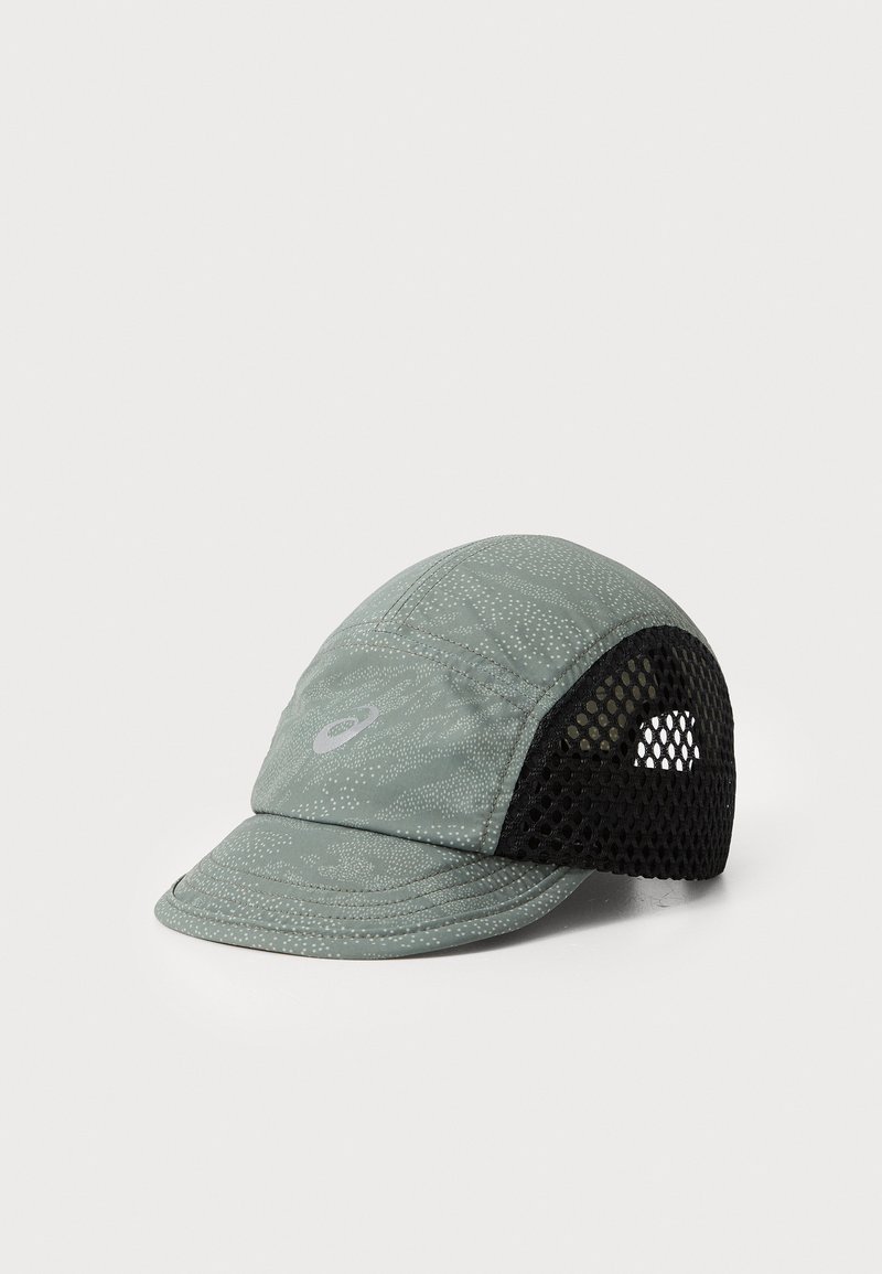 Green cap with a textured pattern, featuring a black mesh side panel and a curved brim. Logo on the front. Lightweight design.