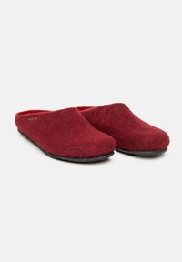 Red wool clogs with a smooth surface, closed back, and a slightly rounded toe. Textured felt material and a black rubber sole.
