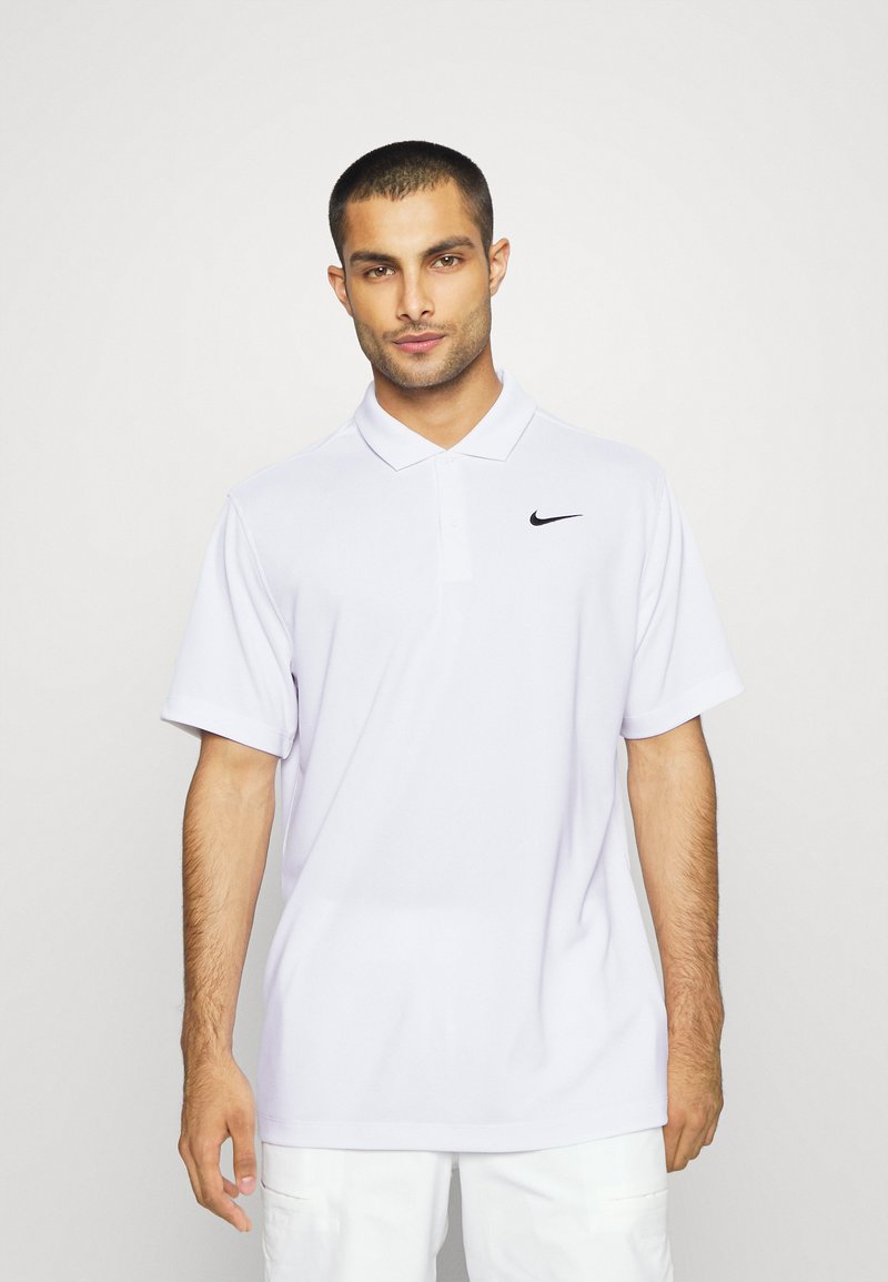 Balta polo marškinėliai, pagaminti iš minkštos medžiagos, su klasikiniais apykakle, trumpomis rankovėmis ir mažu juodu Nike logotipu kairėje krūtinės pusėje.