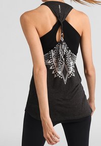 Black and gray tank top with a back twist design, featuring a white geometric pattern on the lower half and a smooth, soft texture.