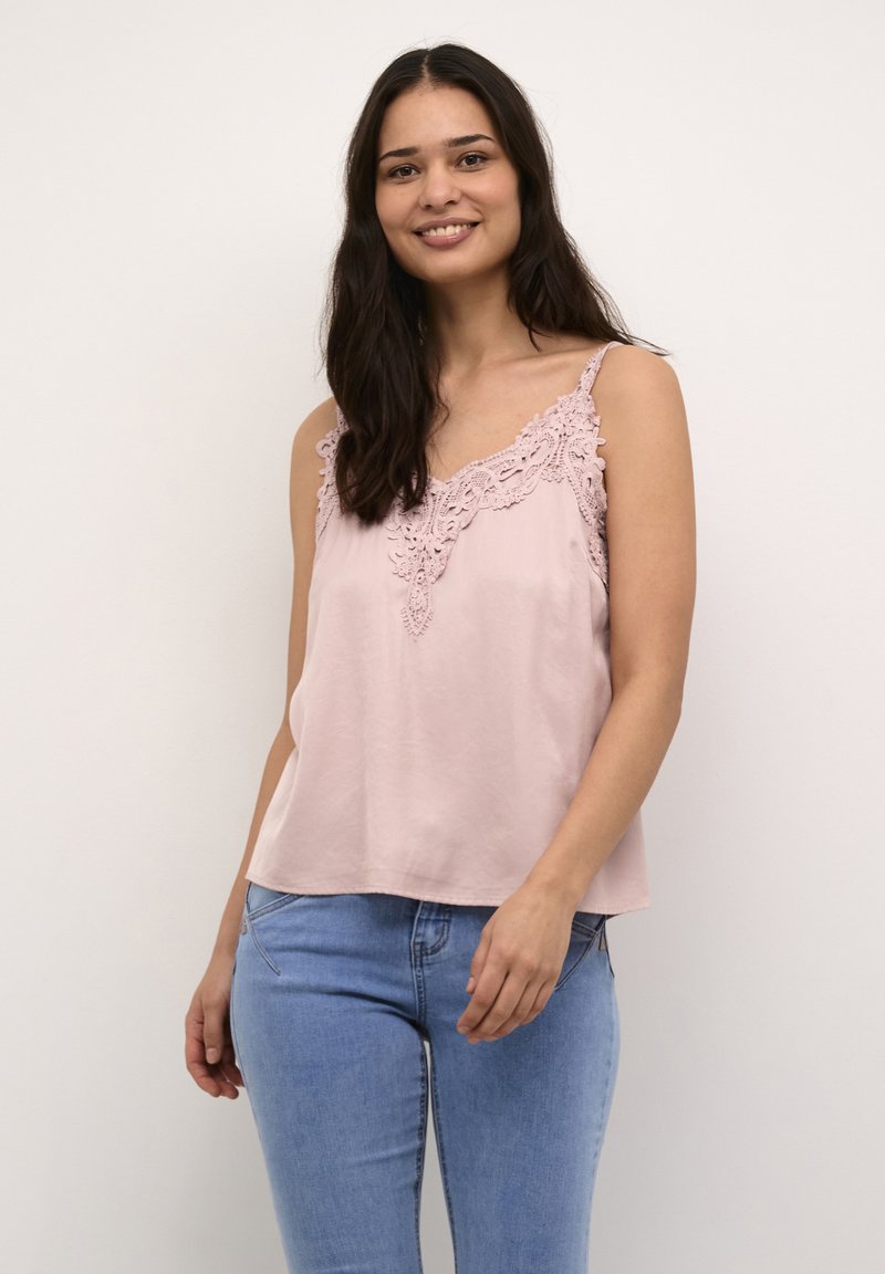 Pink camisole with lace detailing along the neckline, featuring thin straps and a relaxed fit, paired with light blue jeans.