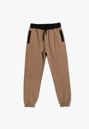 Pantalones jogger beige con cinturilla elástica negra y bolsillos laterales. Fabricados en una tela suave, con puños acanalados y un ajuste relajado.