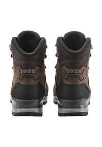 Dunkelbraune Wanderschuhe mit einem Oberteil aus Leder, Gummisohle und verstärktem Absatz. Verfügt über Metallösen und einen gepolsterten Kragen für zusätzlichen Komfort.
