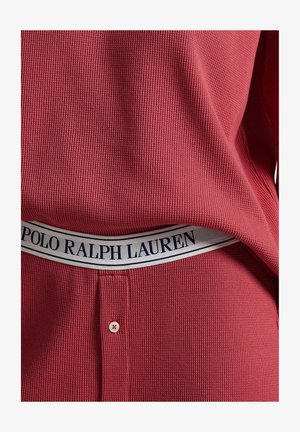 Red ribbed knit top with a soft texture, featuring a crew neckline and a Polo Ralph Lauren branded waistband in navy and white.