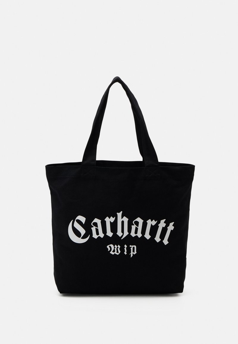 Sac fourre-tout en toile noire avec deux poignées, présentant un grand logo blanc "Carhartt wip" imprimé sur le devant. Forme rectangulaire simple.