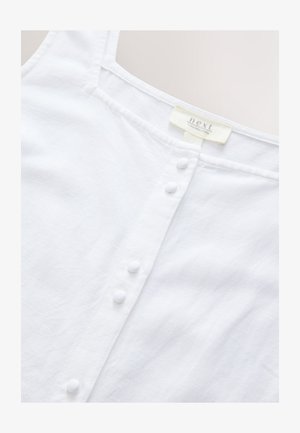 Bílý lněný top se čtvercovým výstřihem, s knoflíkovou légou s bílými knoflíky a jemnou texturovanou látkou. Viditelná značka výrobce.