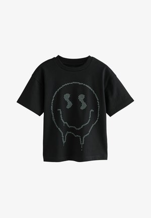 Must musta T-särk lühikeste varrukatega, millel on naeratava näo muster, mis on loodud heledatest nupukestest ning mille alumises servas on tilkuvad detailid.