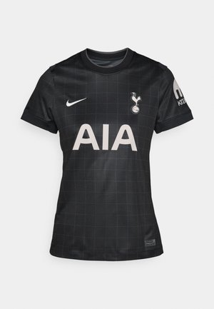 Black football jersey with a grid pattern, featuring a round collar, short sleeves, and the logos of Nike and Tottenham Hotspur.