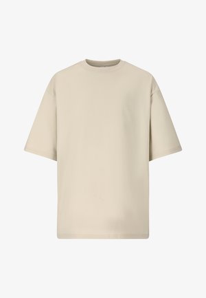 T-shirt beige oversize à manches courtes avec col rond et logo discret en relief sur la poitrine.