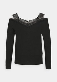 Pull noir décolleté épaules dégagées avec un col en V profond, orné d'une bordure en dentelle au niveau du col et des manches longues. Fabriqué en matière tricotée douce.