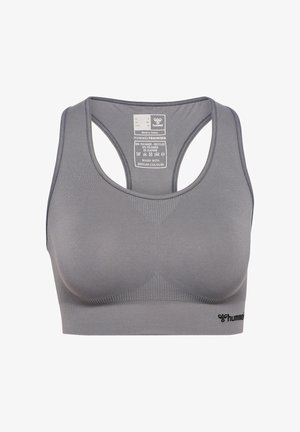 Grå sömlös racerback sportbh med hummel-logotyp nederst till höger och storleks- samt skötselinformation på insidan av bakpanelen.