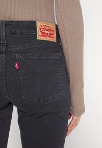 Levi's® SUPERLOW BOOTCUT - Bootcut jeans - first or last