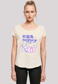 Light beige scoop-neck t-shirt featuring a colorful cartoon graphic of food and a bunny, with text in blue and purple. Soft texture, relaxed fit.