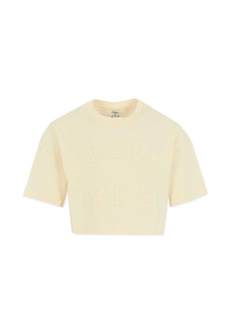 Geknipt crèmekleurig T-shirt van zacht katoen, met reliëftekst "CHLOE" en "PARIJS" op de voorkant. Korte mouwen, ronde halslijn.
