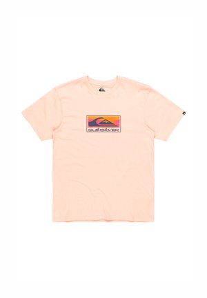 Peach cotton t-shirt with short sleeves featuring a colorful graphic design in the center, displaying waves and the "Quiksilver" logo.