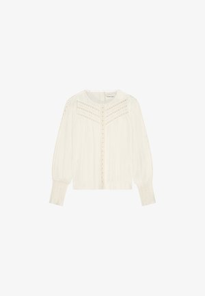 White blouse with long sleeves, button front, textured fabric, and delicate embroidery detailing along the shoulders and chest.