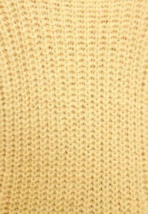 Tissu tricoté en jaune pâle, présentant des points lâches et texturés. Apparence douce avec un motif uniforme.