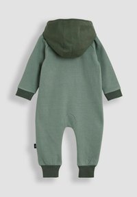 Grüner Baumwoll-Overall mit Kapuze, mit langen Ärmeln, elastischen Bündchen und einem runden Aufnäher auf der Rückseite. Glatte Textur, lässiges Design.