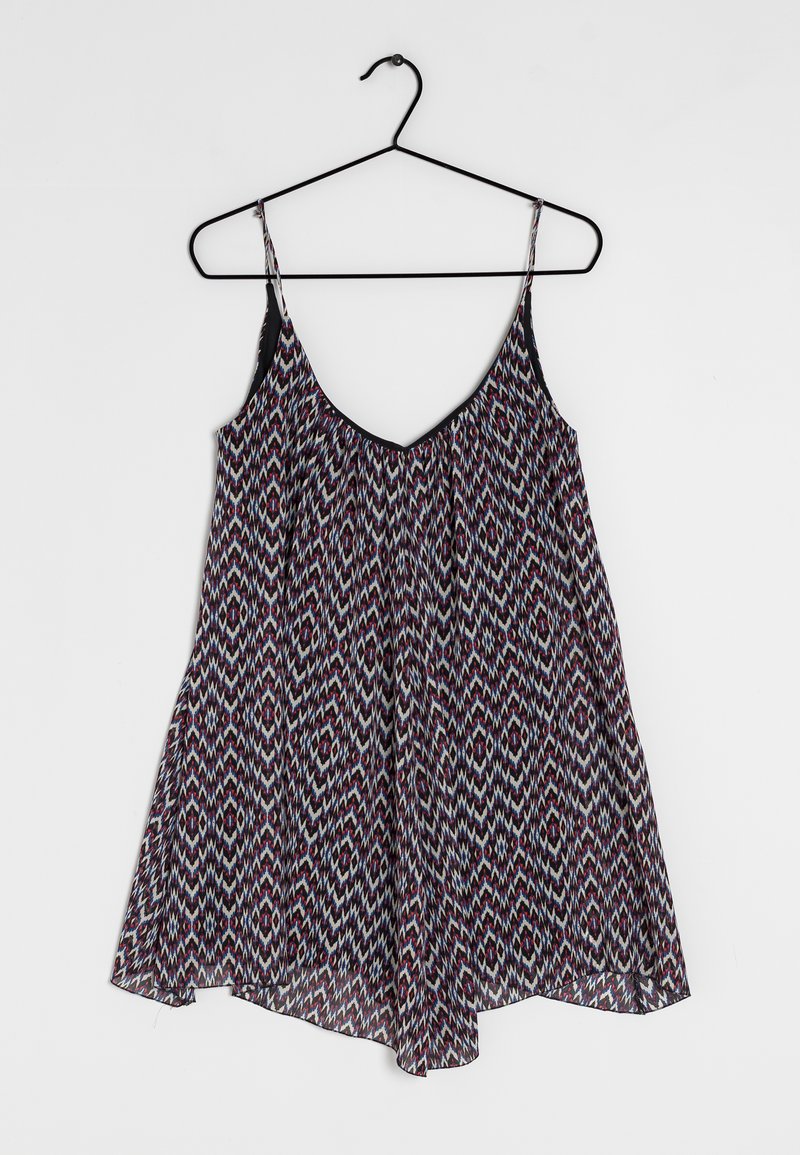 Vloeiende mouwloze jurk met een zwarte rand bovenaan en een meerkleurig zigzagpatroon. De stof lijkt lichtgewicht met een relaxte pasvorm en valt zacht.