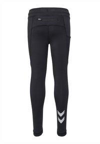Zwarte sportleggings van een gladde, stretchy stof, met een ritssluiting achterzak en reflecterende chevronaccenten op het onderbeen.