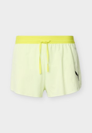Shorts de sport jaune clair avec taille élastique jaune vif et cordon de serrage, comportant un petit logo Puma noir sur la jambe gauche.