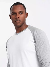 Weißes Langarmshirt mit grauen Raglanärmeln, aus einer Baumwollmischung, Rundhalsausschnitt und glatter Textur. Keine auffälligen Muster oder Akzente.