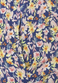 Gėli ų audinys, ant kurių pavyzdžiai geltonų, rožinių ir raudonų gėlių tamsiai mėlyname fone. Minkštas tekstūra su kartojančiu gėlių raštu ir žaliais akcentais.