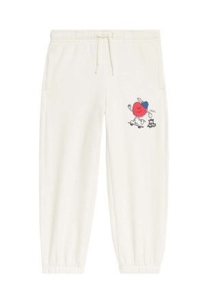 White sweatpants with elastic cuffs, drawstring waist, side pockets, and a graphic of a red apple wearing a blue cap skateboarding with "The Big Apple" text.