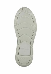 Suola di una scarpa, beige chiaro con superficie testurizzata, caratterizzata da un motivo a onde e righe per la presa. Marcata con "Tamaris 37" per la misura.
