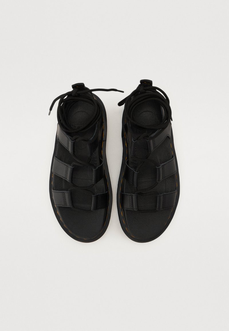 Black sandals with a textured upper, featuring three adjustable straps and a cushioned sole. Laces secure the fit for comfort.