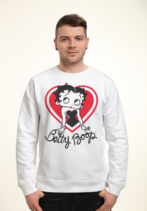 Biała bluza z grafiką Betty Boop w kształcie serca, z czarnymi i czerwonymi akcentami. Zauważono miękki materiał i ściągacze.