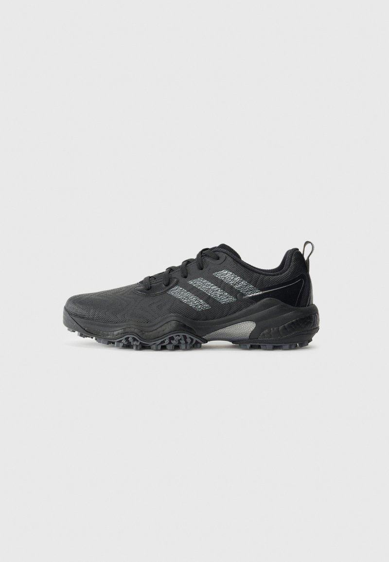 Chaussure de sport noire avec une semelle texturée et trois bandes réfléchissantes grises sur le côté, conçue pour la course en sentier ou une utilisation en extérieur.