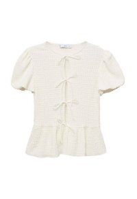 Blusa bianca con texture, maniche a sbuffo, cintura frontale e orlo peplum. Realizzata in un tessuto leggero con un motivo a rilievo sobrio.