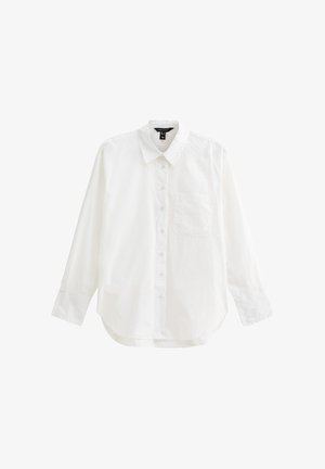 Camisa blanca de manga larga hecha de algodón, con frente abotonado, cuello, un bolsillo en el pecho y dobladillo redondeado. Textura suave.